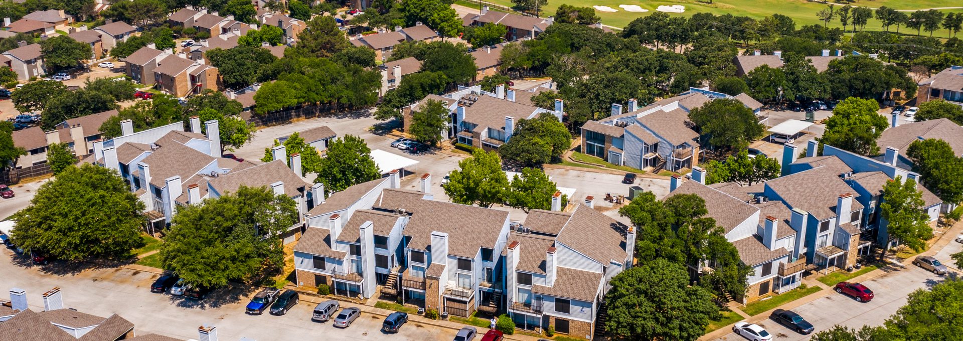 an aerial view of the apartment complex in the suburbs at The  Biltmore