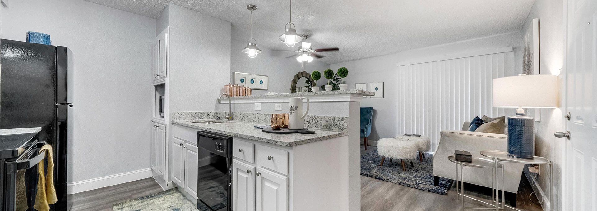 a kitchen with white cabinets and a white counter top at The  Biltmore